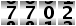 7702