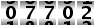 07702